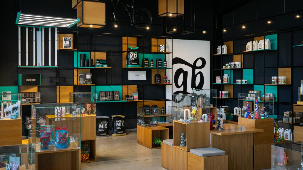 Contemporary cannabis store showcasing gardening products on wooden shelves.